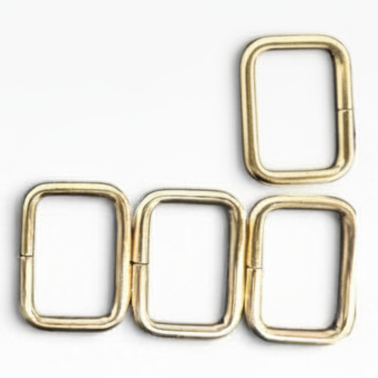 Set di anelli rettangolari in metallo dorato per borse Merceria & Tendenze su sfondo bianco