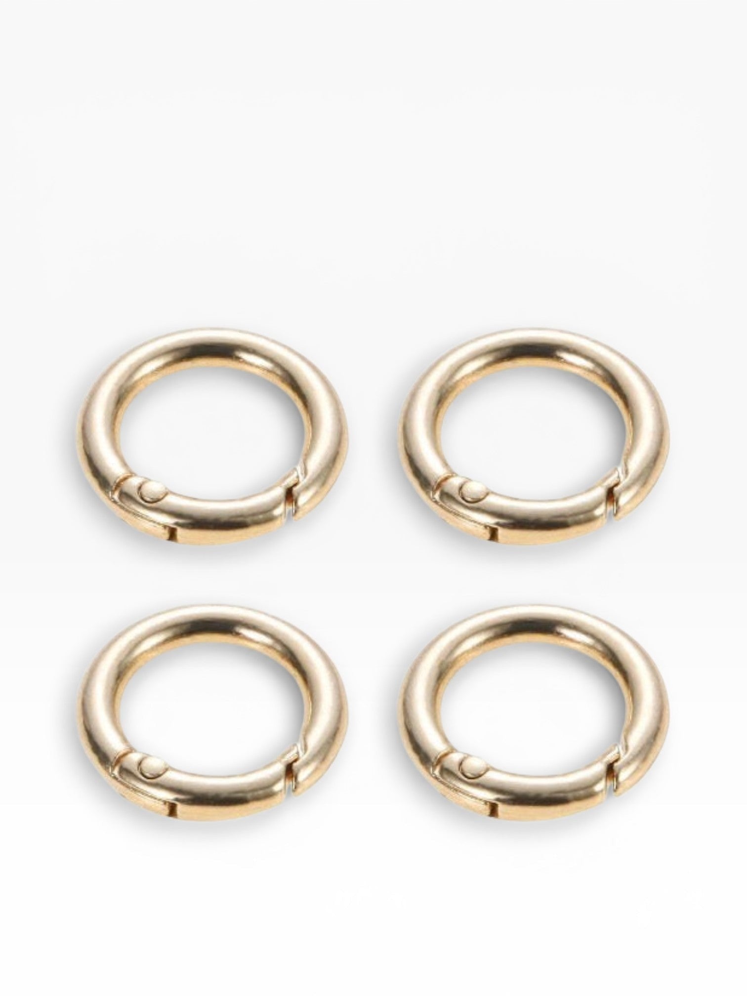 Set di 4 moschettoni rotondi a scatto color oro di Merceria & Tendenze, ideali per borse e accessori fai-da-te.